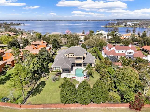 birds eye view of property with a water view and a residential view