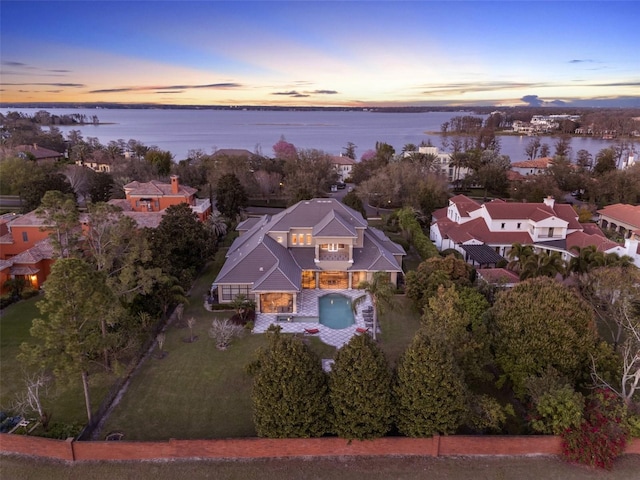 aerial view at dusk with a water view