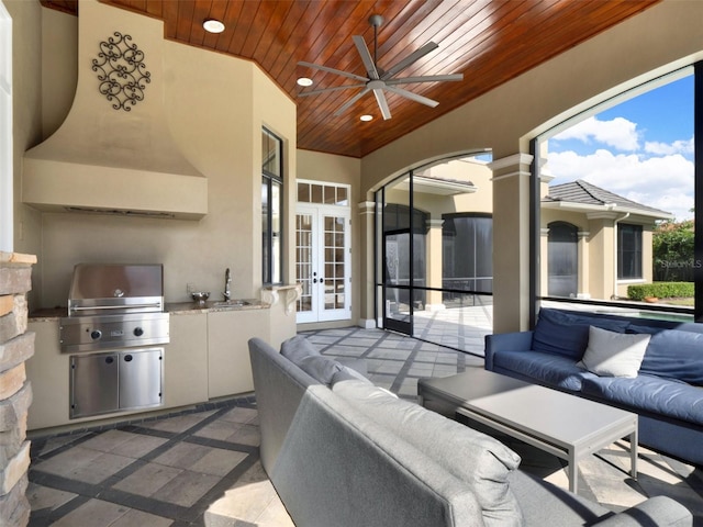 view of patio featuring a grill, outdoor lounge area, a sink, and french doors