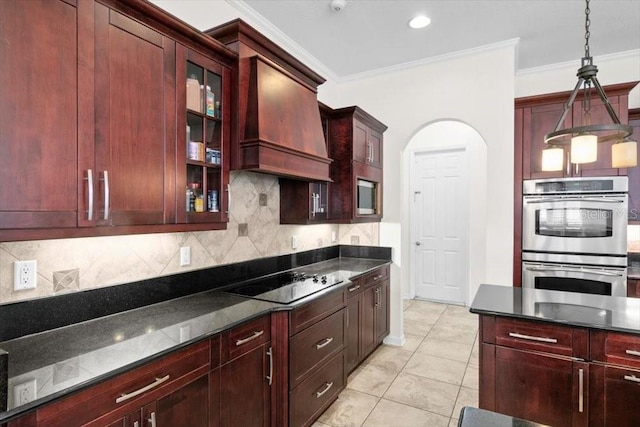 kitchen featuring arched walkways, custom exhaust hood, stainless steel double oven, dark brown cabinets, and black electric cooktop