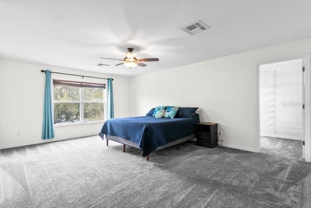 carpeted bedroom featuring ceiling fan, visible vents, and baseboards