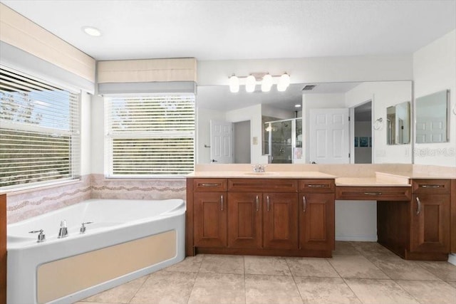 bathroom with a bath, a stall shower, tile patterned flooring, and vanity