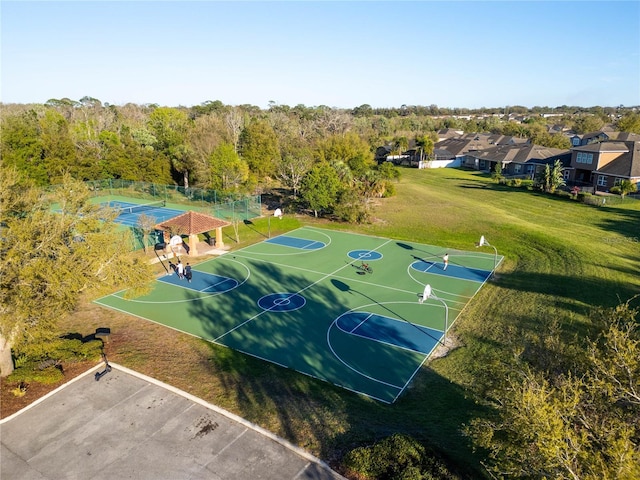 view of sport court featuring community basketball court, fence, and a yard