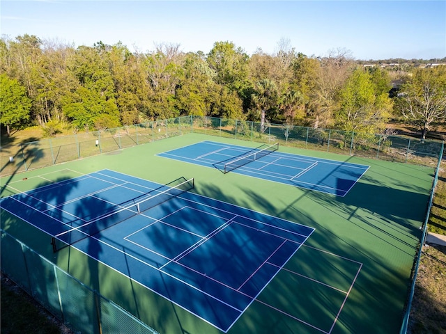 view of tennis court featuring fence