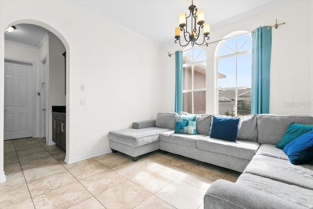 living area featuring arched walkways, crown molding, light tile patterned floors, an inviting chandelier, and baseboards