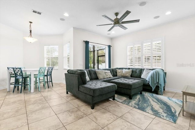 living room with light tile patterned floors, visible vents, crown molding, and recessed lighting