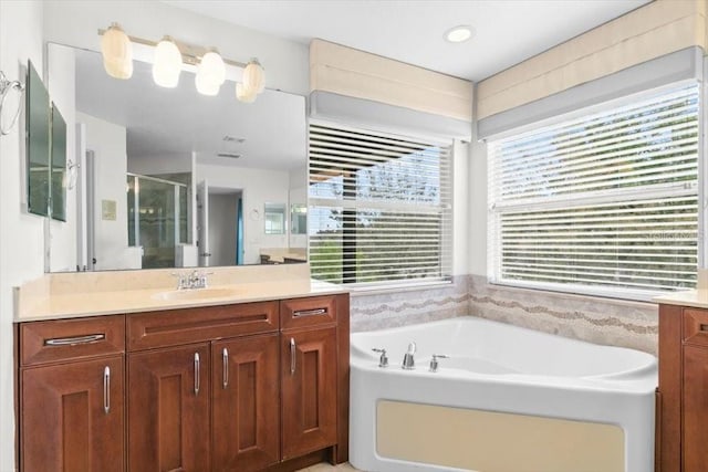 full bath with a garden tub, a shower stall, and vanity