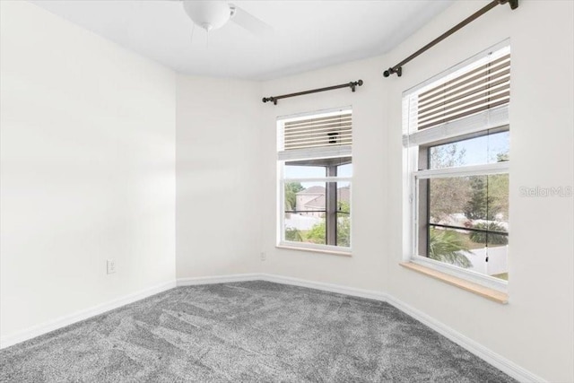 carpeted spare room with baseboards