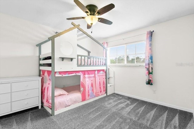 carpeted bedroom with ceiling fan and baseboards