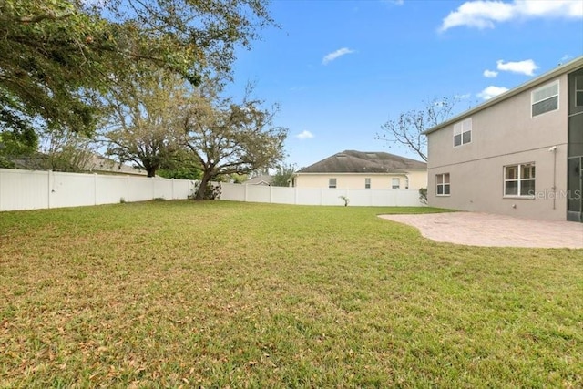 view of yard with a patio and a fenced backyard