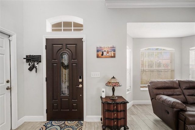 entrance foyer with light wood-style flooring and baseboards