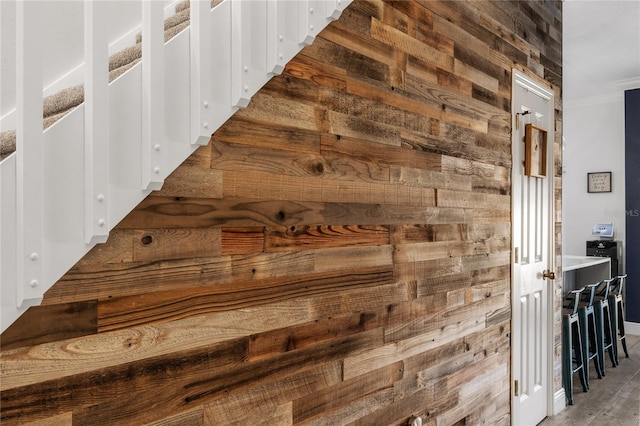 corridor featuring wood walls