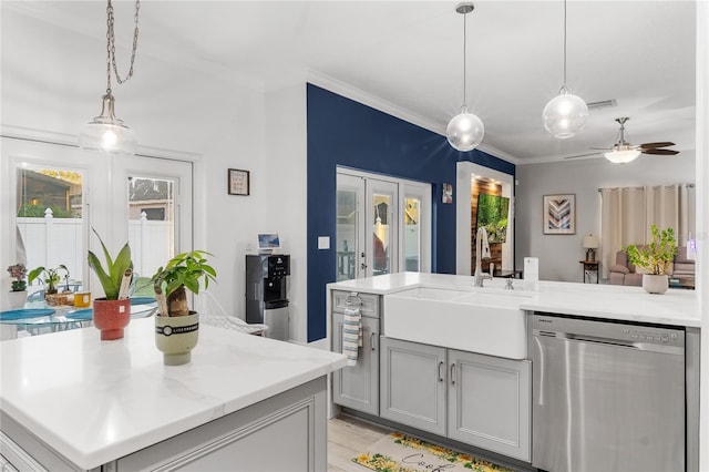 kitchen featuring visible vents, crown molding, dishwasher, light countertops, and a sink