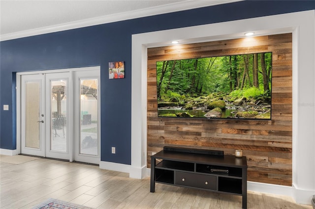 doorway to outside featuring crown molding, wood finished floors, baseboards, and french doors