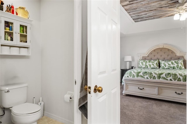 carpeted bedroom featuring baseboards