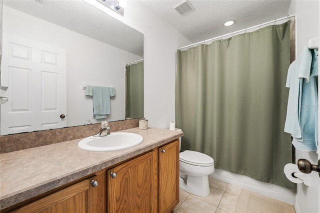 bathroom with vanity, visible vents, tile patterned flooring, a textured ceiling, and toilet