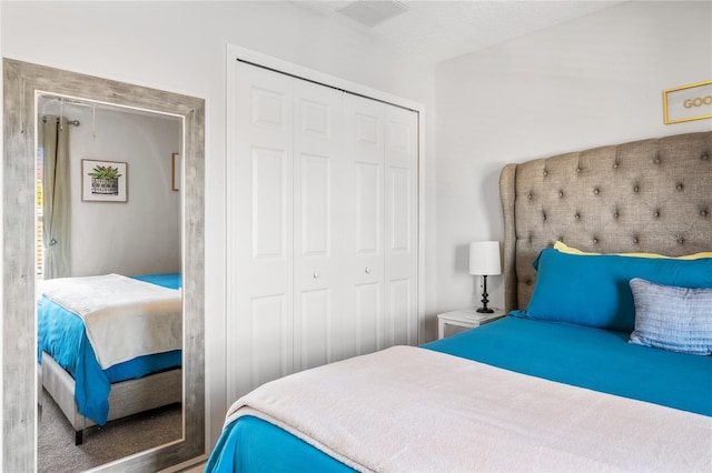 bedroom featuring a closet and visible vents