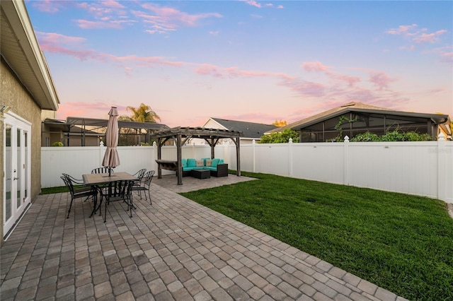 patio terrace at dusk featuring a lawn, a fenced backyard, outdoor lounge area, and a pergola