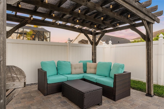 patio terrace at dusk featuring an outdoor hangout area, a pergola, and a fenced backyard