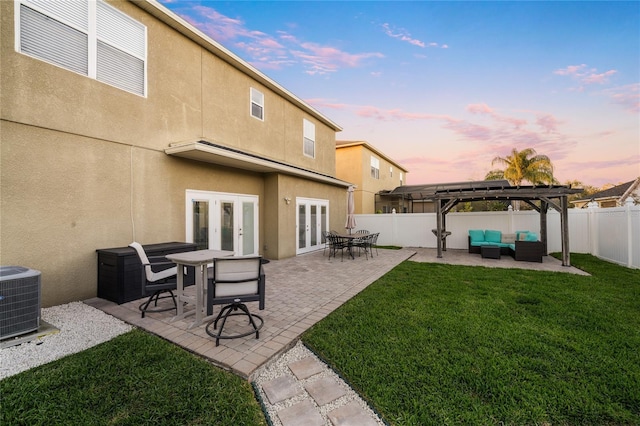 rear view of house featuring central air condition unit, a pergola, a fenced backyard, french doors, and an outdoor hangout area