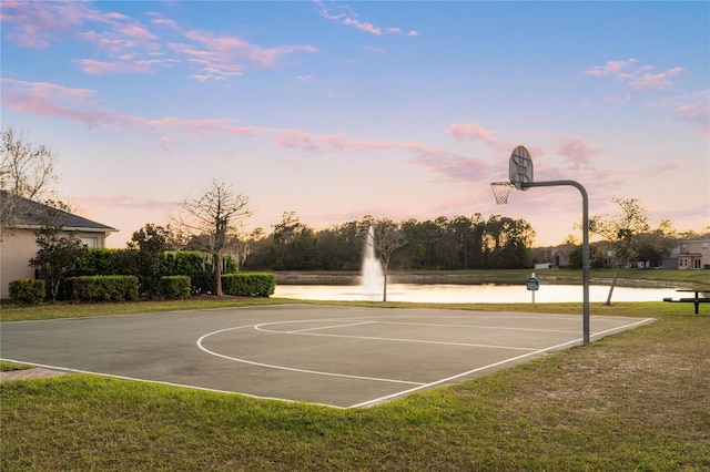 view of basketball court with a lawn, community basketball court, and a water view