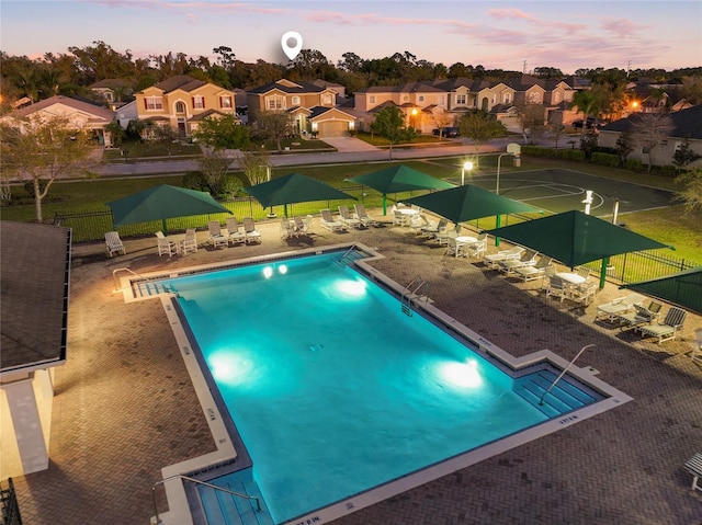 pool featuring a patio area, a residential view, and fence