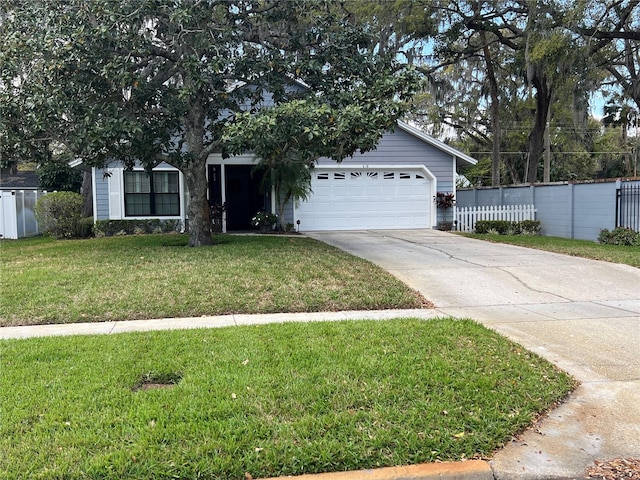 view of front of house with an attached garage, driveway, a front yard, and fence