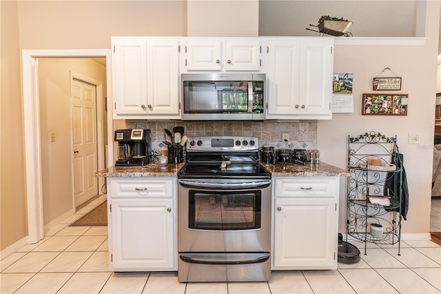 kitchen with white cabinets, tasteful backsplash, and appliances with stainless steel finishes