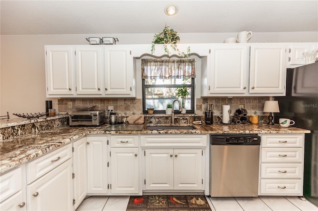 kitchen featuring dishwasher, stone counters, backsplash, and a sink