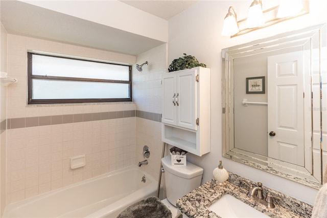 bathroom featuring toilet, shower / bath combination, and a sink