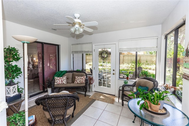 sunroom featuring a ceiling fan, visible vents, and a wealth of natural light