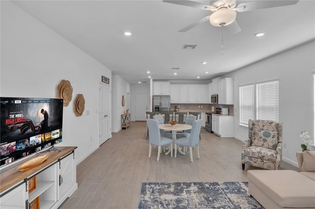 dining area featuring recessed lighting, a ceiling fan, baseboards, visible vents, and light wood-style floors