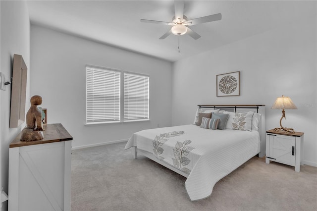 carpeted bedroom featuring ceiling fan and baseboards