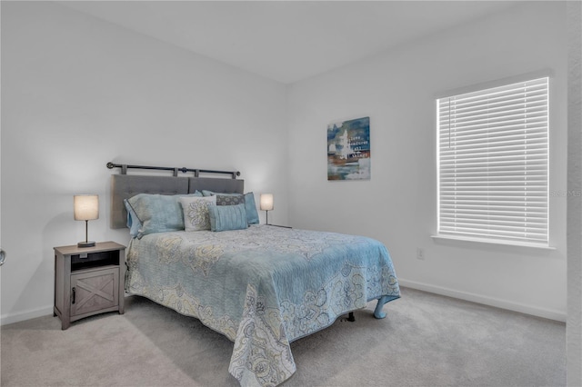 bedroom featuring carpet and baseboards