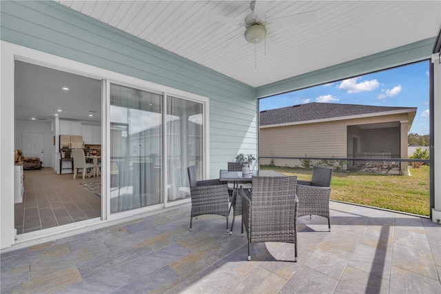 exterior space featuring outdoor dining area and a ceiling fan