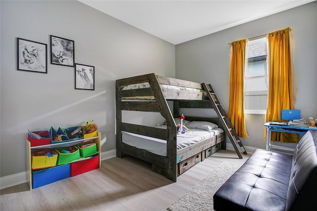 bedroom featuring baseboards and wood finished floors