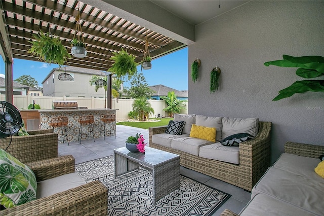 view of patio featuring an outdoor hangout area, a grill, a pergola, exterior kitchen, and a fenced backyard