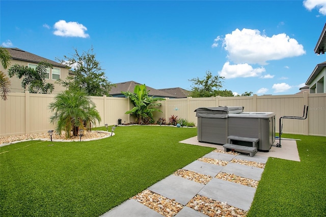 view of yard with a fenced backyard and a hot tub