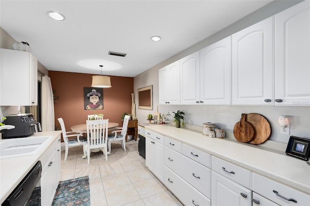 kitchen featuring white cabinets, a sink, dishwasher, and light tile patterned floors