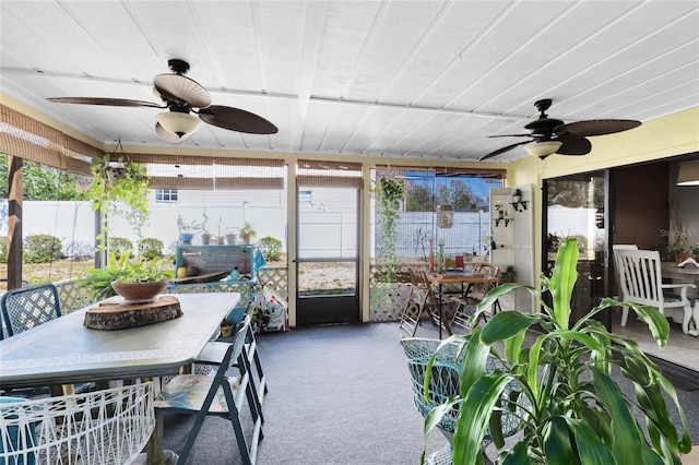 sunroom / solarium featuring plenty of natural light and a ceiling fan