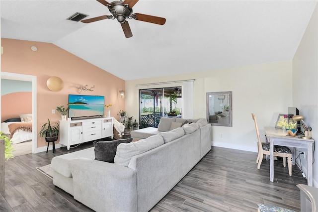 living area featuring lofted ceiling, wood finished floors, visible vents, and baseboards