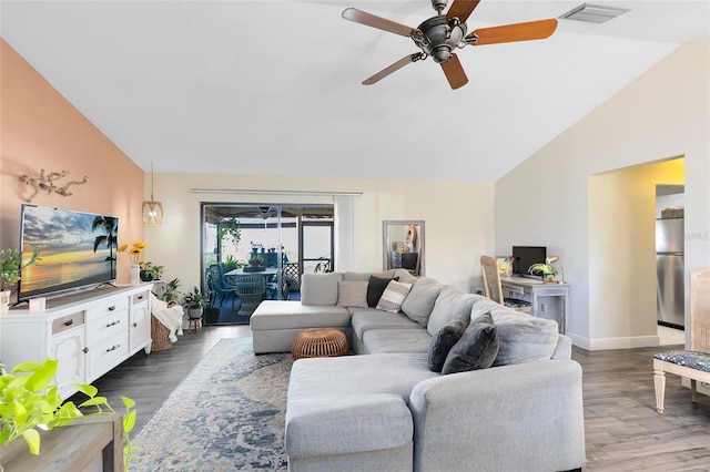 living area featuring lofted ceiling, ceiling fan, visible vents, and dark wood finished floors