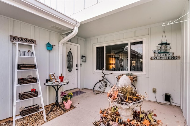 entrance to property featuring visible vents and board and batten siding