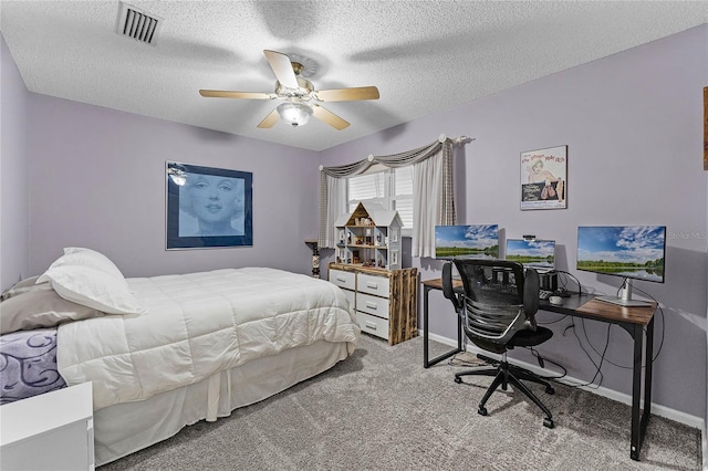 carpeted bedroom with visible vents, baseboards, a textured ceiling, and ceiling fan