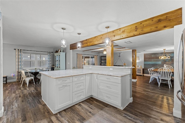 kitchen featuring dark wood-style floors, white cabinetry, and decorative light fixtures