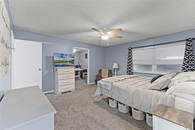 bedroom featuring baseboards, light colored carpet, ceiling fan, and a textured ceiling