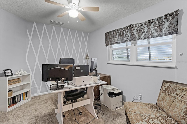 carpeted office with visible vents, a textured ceiling, and ceiling fan