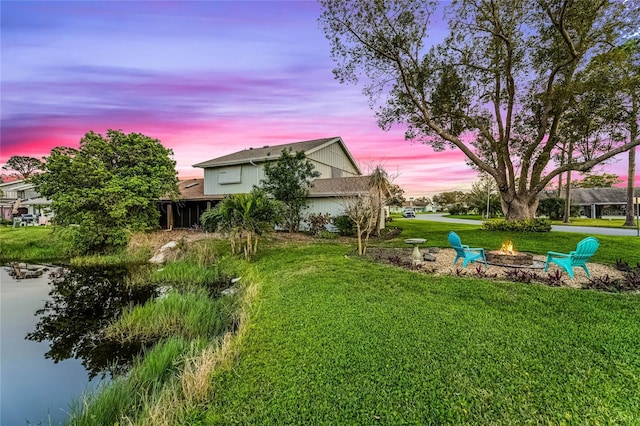 yard at dusk featuring a fire pit