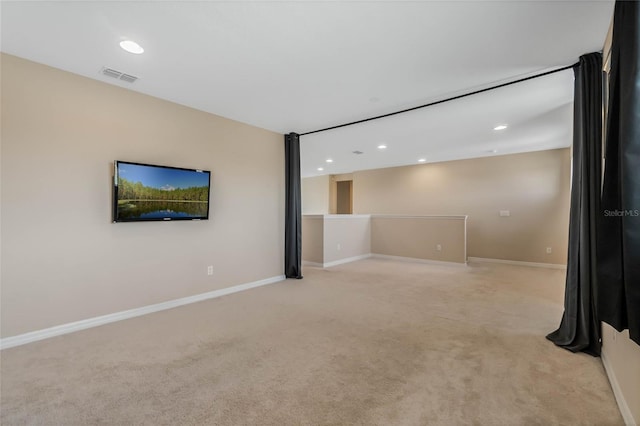 unfurnished living room with recessed lighting, visible vents, light carpet, and baseboards