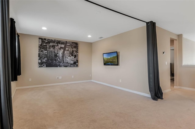 unfurnished room with light carpet, baseboards, and recessed lighting